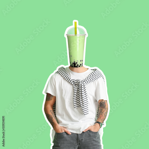 Tattooed man with cup of ta...