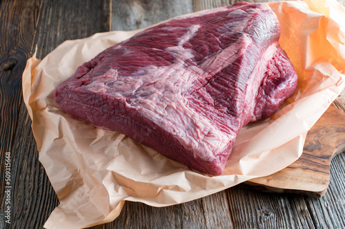 Beef brisket raw and uncooked  on wooden table