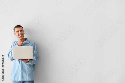 Thoughtful young man using ...
