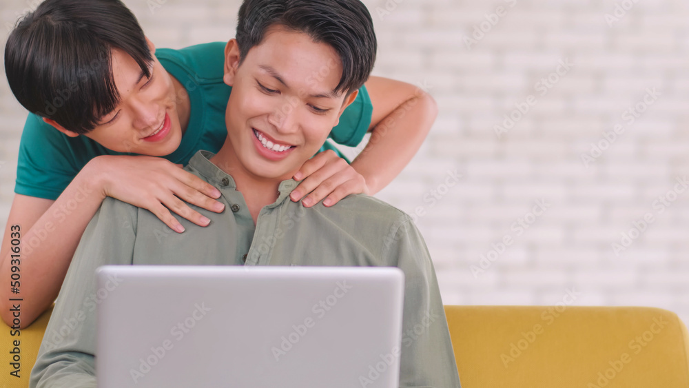 Asian gay takes care of his partner while working on his laptop at home. Asian gay takes care of his partner while working on his laptop at home.