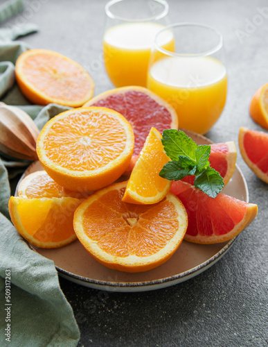 Glasses of juice and citrus fruits