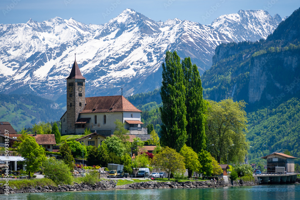 church with snowy alps over Brienz lake in Switzerland