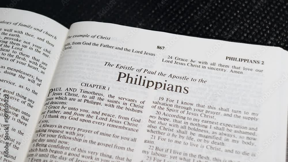 Close Up Shot of Bible Page Turning to the book of Philippians Close Up Shot of Bible Page Turning to the book of Philippians