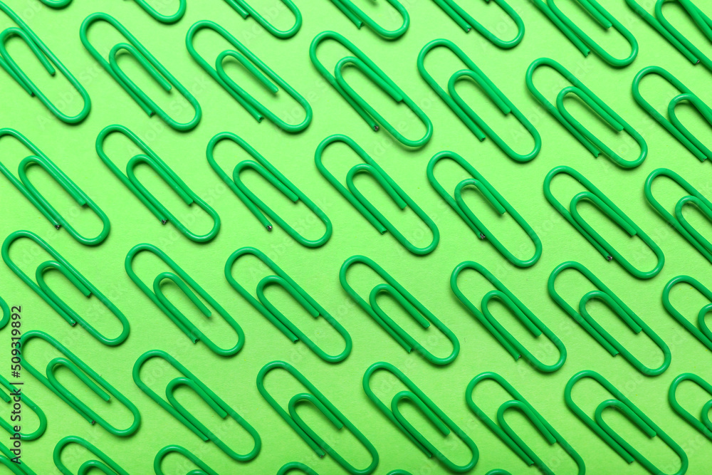 Green paper clips on color background Green paper clips on color background