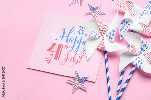 Greeting card with text HAPPY 4TH OF JULY, paper windmills and stars on pink background photo