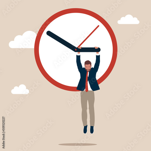 Man hangs on the arrow of a huge clock