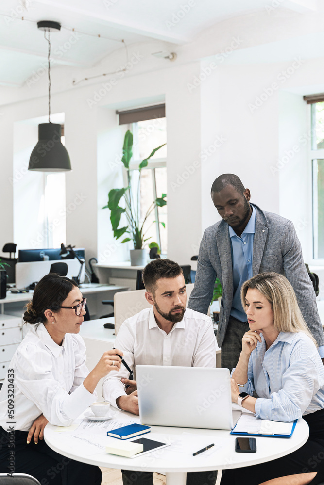 Multi-ethnic business people during meeting in modern office Multi-ethnic business people during meeting in modern office