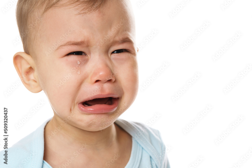 Closeuo shot of face of crying little boy in romper. Closeuo shot of face of crying little boy in romper.