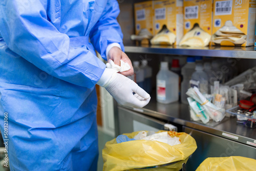 Photography Male surgeon removing surgical gloves in operation theater at hospital