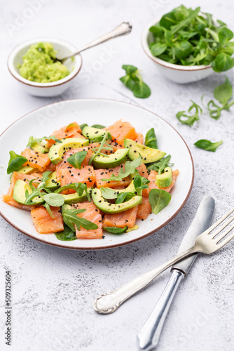 Salmon salad with avocado,  for keto and low carb diet. Rusty background, top view, copy space.