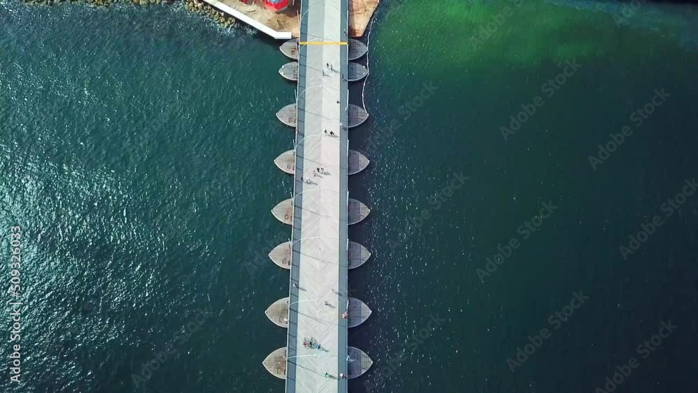 Tilt up aerial view of the Queen Emma Bridge in St. Anne's Bay towards the Otrobanda district in the city of Willemstad, capital of Curacao, Dutch Caribbean island. Tilt up aerial view of the Queen Emma Bridge in St. Anne's Bay towards the Otrobanda district in the city of Willemstad, capital of Curacao, Dutch Caribbean island.