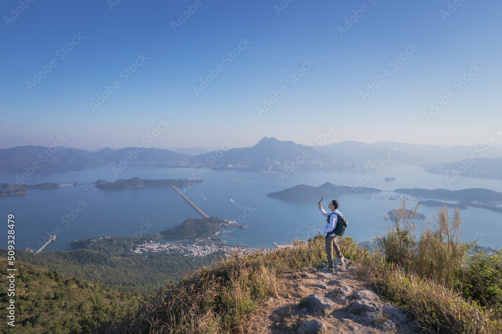 Epic view of hiker man on the mountain of Pat Sin Leng, Tai Po Epic view of hiker man on the mountain of Pat Sin Leng, Tai Po