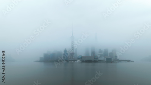 Overlook Wonderland lujiazui CBD in Shanghai in the Overlooking the skyscrapers in Lujiazui, the financial center of Shanghai Pudong, across the bank in the fog photo