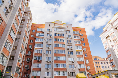 A typical brick multi-storey apartment building against the sky. 