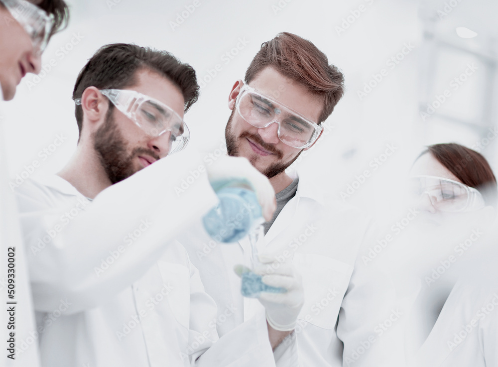 group of scientists working with chemicals group of scientists working with chemicals
