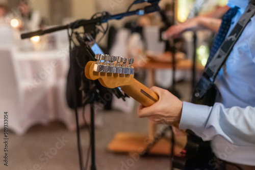 Top part of a wooden guitar being played