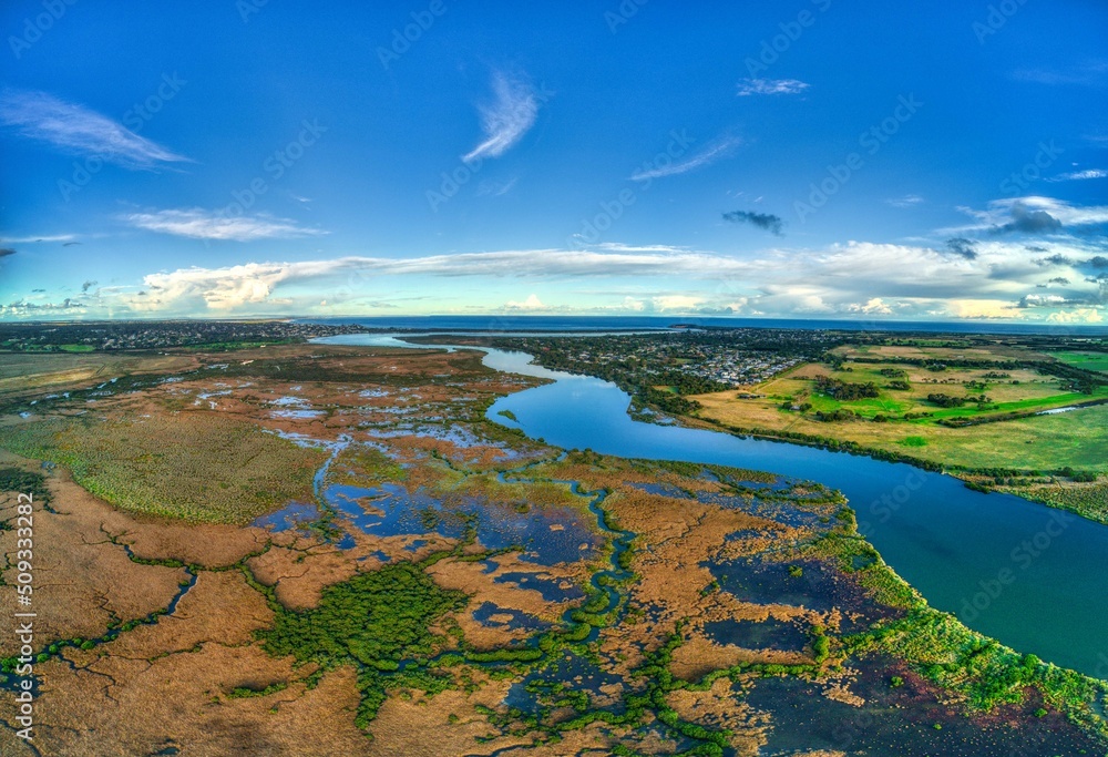 Aerial footage looking downstream towards the mouth of the Barwon River near Barwon Heads, Victoria, Australia. May 2022
