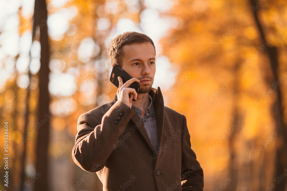 business man talking on a mobile phone while walking on the street business man talking on a mobile phone while walking on the street