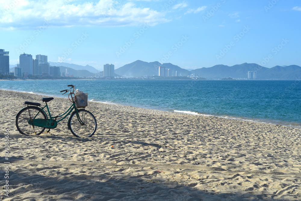 Fototapeta premium Lonely bicycle parked on sandy beach