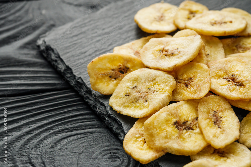 delicious dried banana on a black wooden rustic background