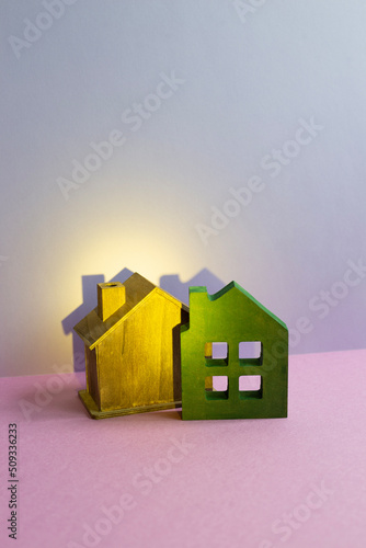 House model on purple desk. purple wall background. Real estate concept