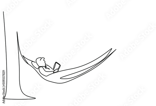 man lying in hammock on tree in garden on vacation reading a book calmly and focused