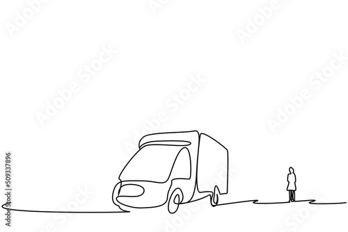 A lonely woman goes on vacation with a caravan. image of woman with her back turned with a camper car next to her