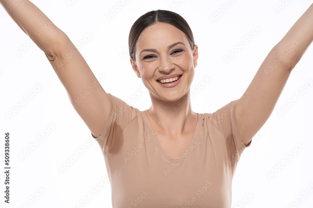 portrait of a beautiful happy woman with sweaty armpits on a white studio background portrait of a beautiful happy woman with sweaty armpits on a white studio background