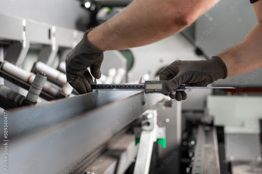 Iron profile measurement. Close-up of hands. Working with iron. Sliding gauge Iron profile measurement. Close-up of hands. Working with iron. Sliding gauge