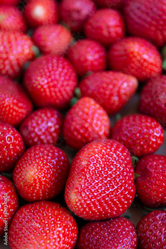 Aerial view of strawberries with selective focus, vertical