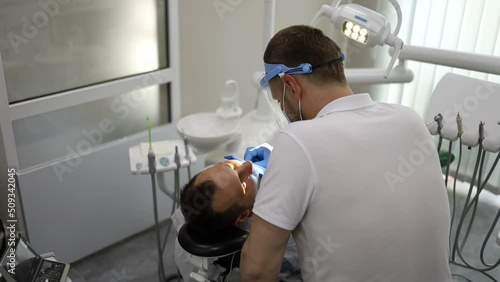real treatment. reportage. the dentist injects an anesthetic into the patient before treatment or tooth extraction. anesthesia in dentistry. anesthetization. photo