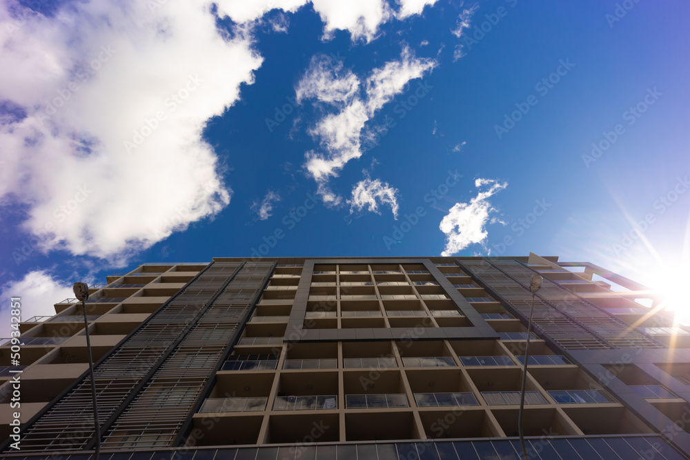 Fototapeta premium Residential high rise apartment building in inner Sydney suburb NSW Australia. Residential complex in leafy suburbia. Urban living high density suburban city 