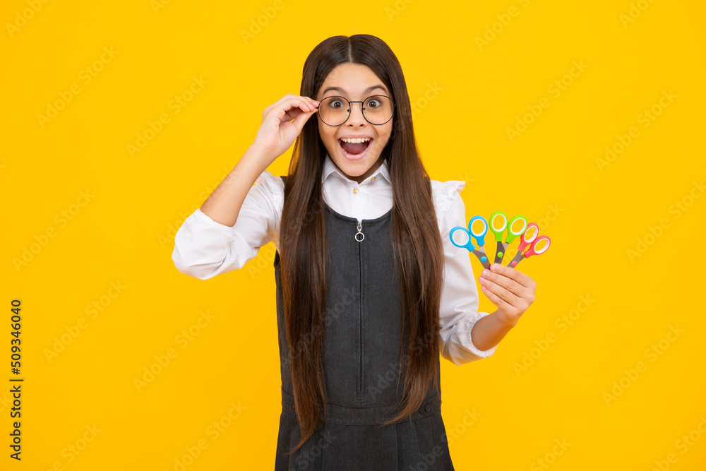Childrens creativity, arts and crafts. Teenage girl with scissors, isolated on yellow background. Childrens creativity, arts and crafts. Teenage girl with scissors, isolated on yellow background.