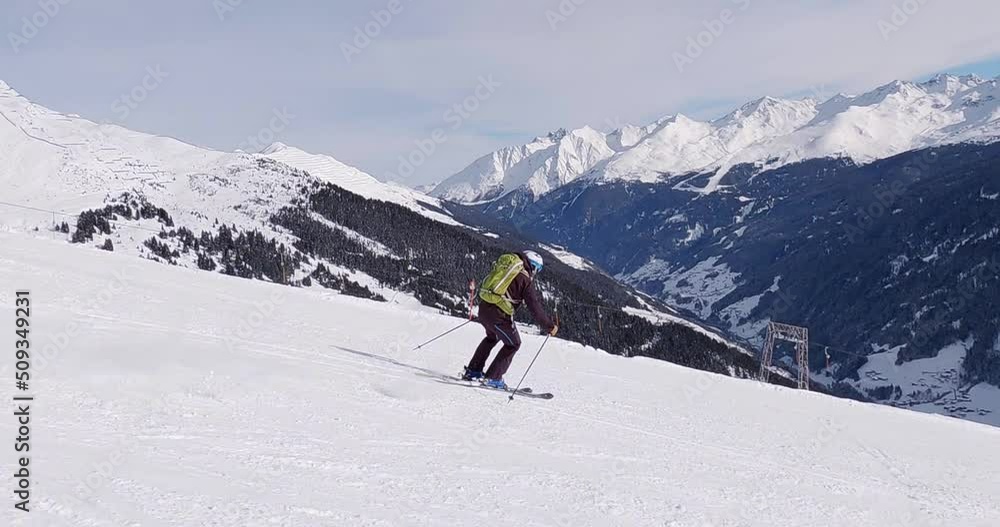 High speed skiing in the tyrolean mountains on a perfect groomed ski slope. Professional follow camera skiing in high alpine terrain in beautiful sun light 4K. High speed skiing in the tyrolean mountains on a perfect groomed ski slope. Professional follow camera skiing in high alpine terrain in beautiful sun light 4K.