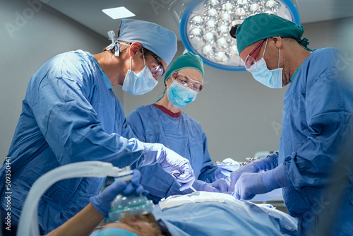 Canvastavla Team of surgeons performing operation at hospital