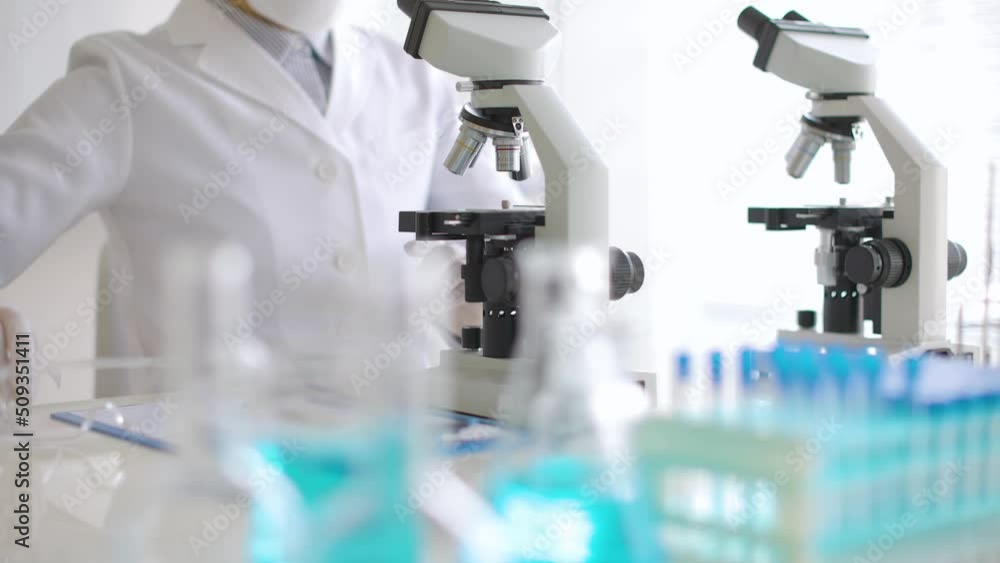 scientist in laboratory with microscope scientist in laboratory with microscope