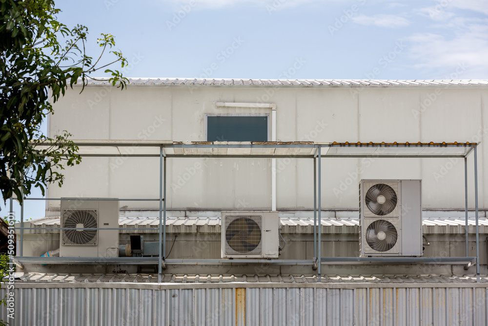 Air conditioner compressor installed in old building. Outdoor split ...