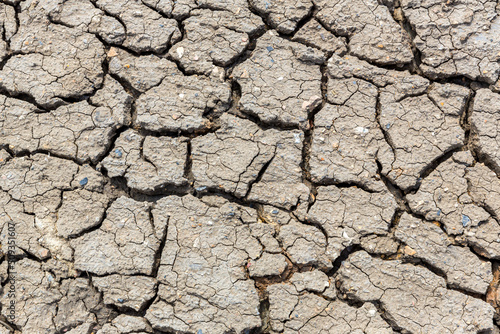 Fotografi Cracked earth. Cracked mud from drought in the desert. Dry soil