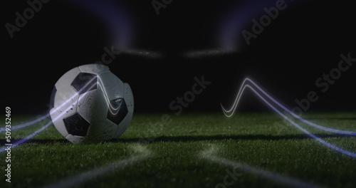Image of neon shapes over football player kicking ball at stadium © vectorfusionart