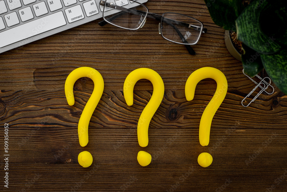 Question mark signs on office table. Customer support servise or FAQ concept Question mark signs on office table. Customer support servise or FAQ concept