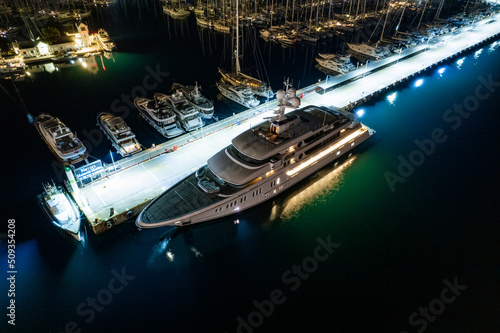 Luxury motor super yacht moored to pier at night (aerial drone photo). Marmaris, Turkey © Oleg Polyakov