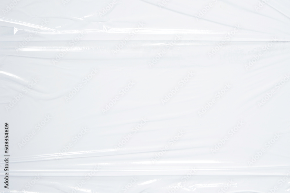 Transparent plastic wrap on white color background. Crumpled