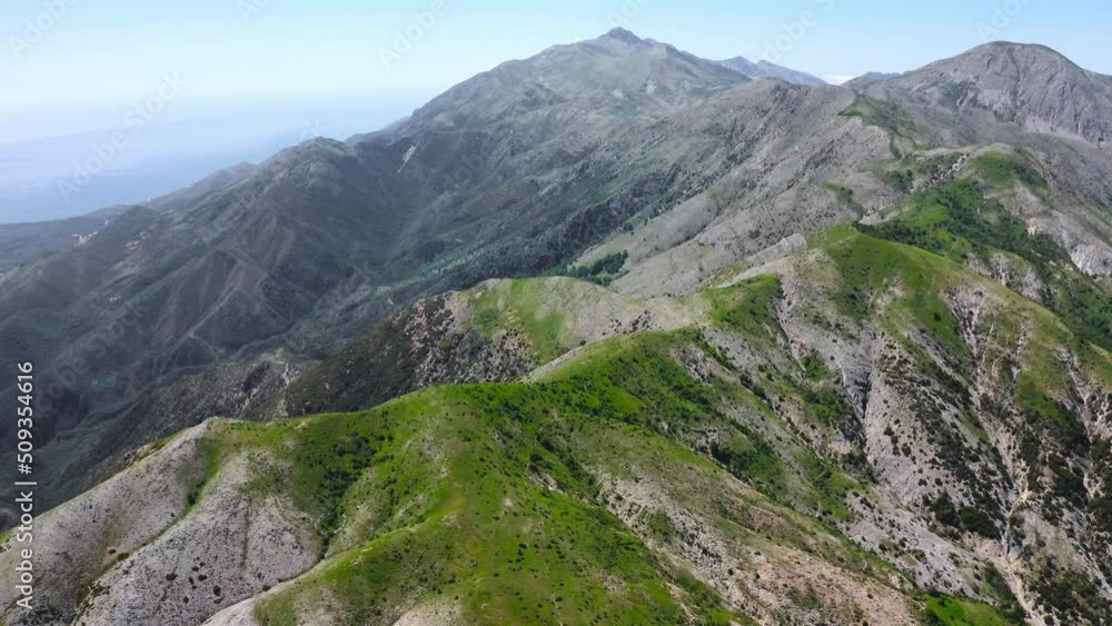 Drone aerial view of the top of a high mountain range with clear blue sky Drone aerial view of the top of a high mountain range with clear blue sky