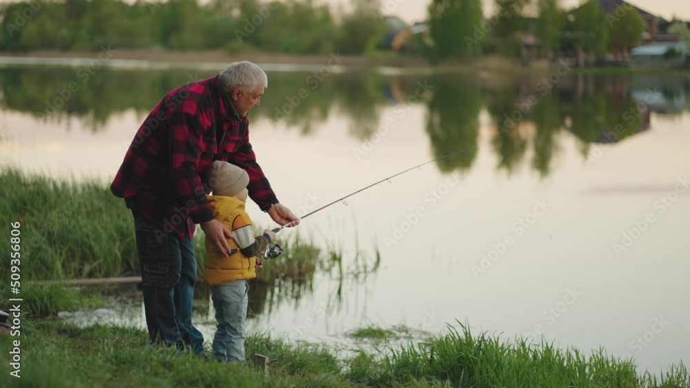 rest in nature, grandfather and grandson are fishing together in morning, beautiful lake shore rest in nature, grandfather and grandson are fishing together in morning, beautiful lake shore