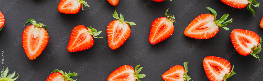 Flat lay of juicy strawberries on black background, banner.