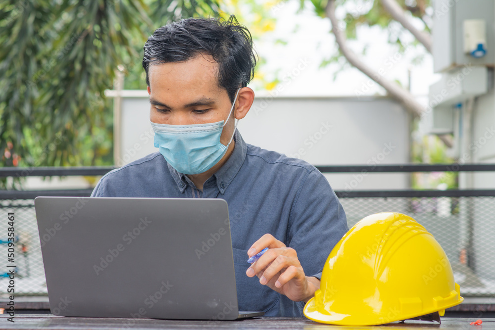 Asian engineer using computer working construction Asian engineer using computer working construction
