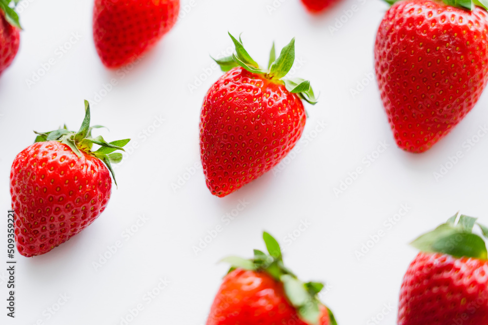 High angle view of ripe strawberries on white background. High angle view of ripe strawberries on white background.