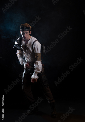 A guy in a steampunk image, a pilot or a mechanic. Retro style, fantastic image. portrait in smoke.