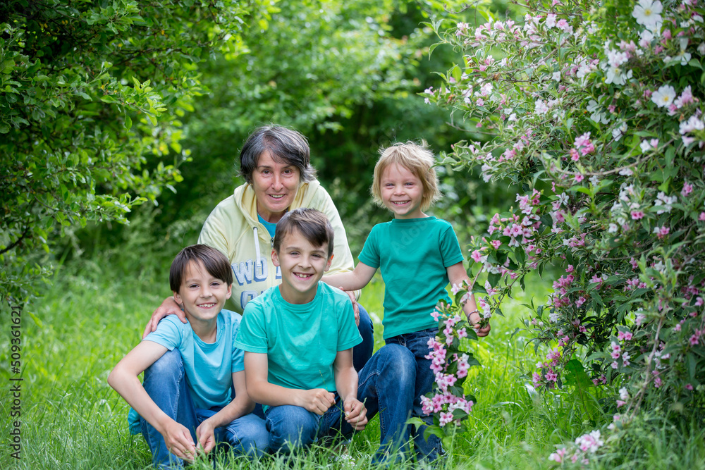 Grandmother and grandchildren, playing together in the park, spring Grandmother and grandchildren, playing together in the park, spring
