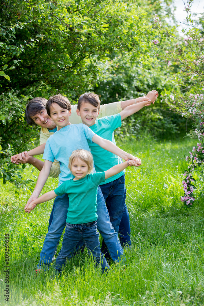Grandmother and grandchildren, playing together in the park, spring Grandmother and grandchildren, playing together in the park, spring